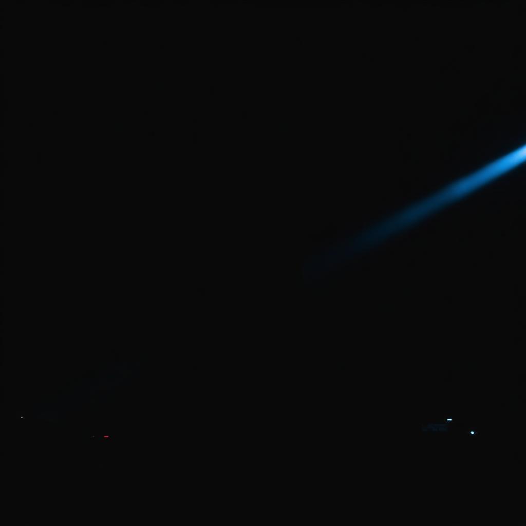 Cold blue stage beam cutting through darkness